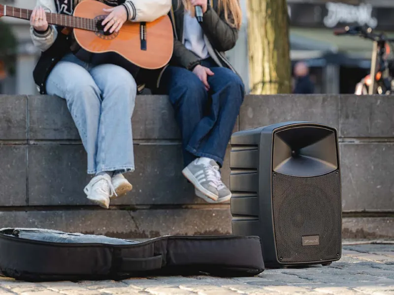 Portable PA speaker with microphone used for live music outdoors