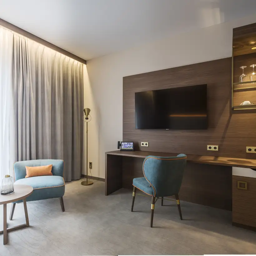 Hotel room with brass JUNG LS 990 sockets on a wooden wall