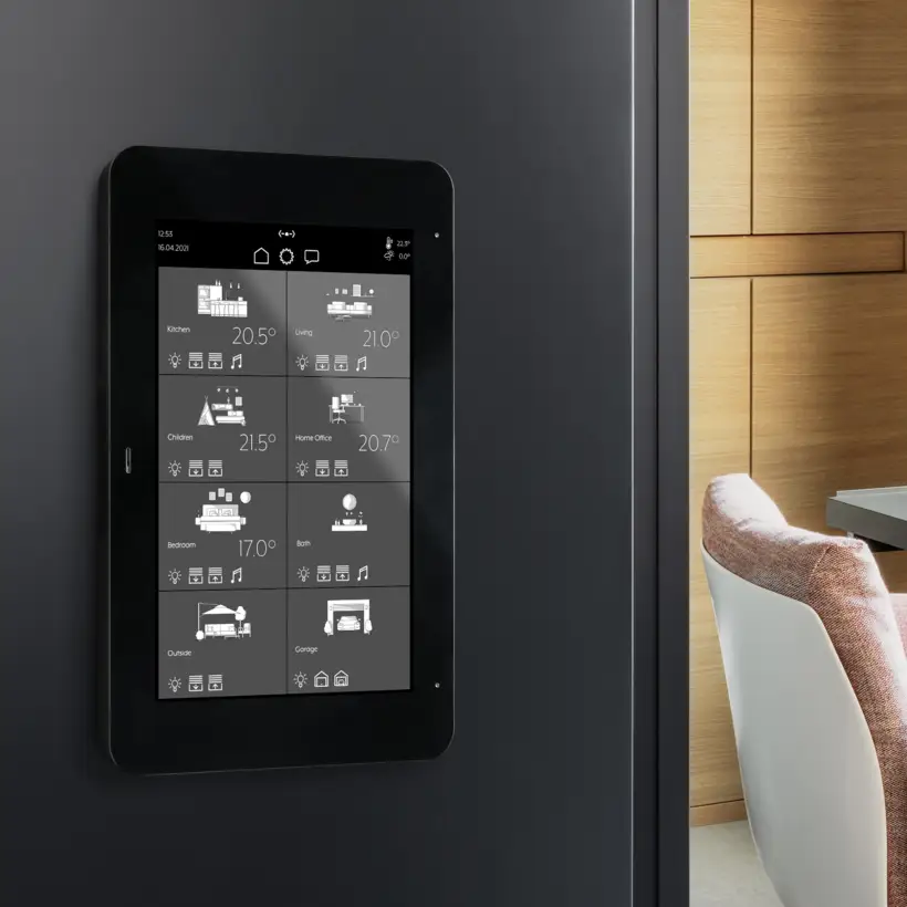 JUNG KNX Smart Panel 8 touch display mounted on a dark wall showing room controls