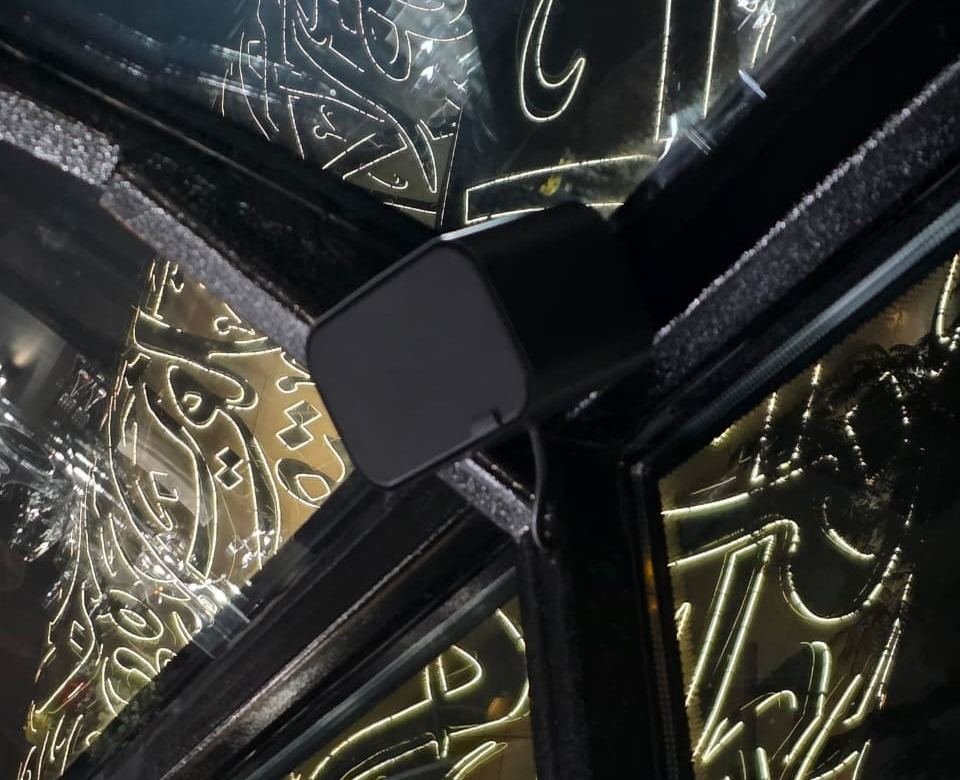Close-up of an Artsound speaker corner-mounted against decorative interior panelling on a restaurant bus