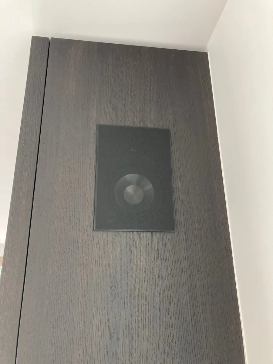 Black Artsound in-wall speaker set flush into dark wood joinery