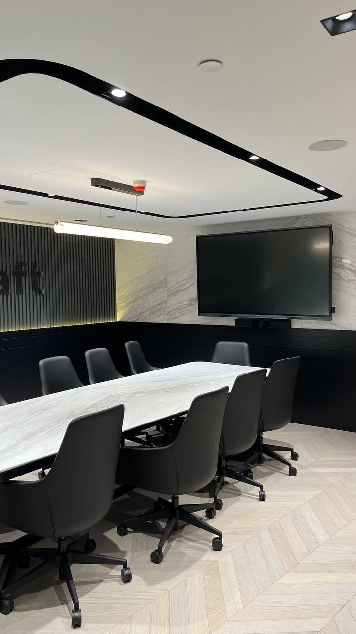 Downtown Dubai office boardroom with in-ceiling speaker, chairs and wall-mounted screen